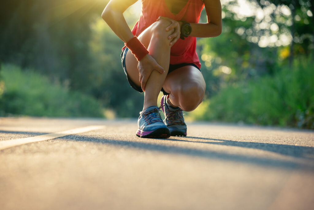 Woman runner got sports injury running on forest trail